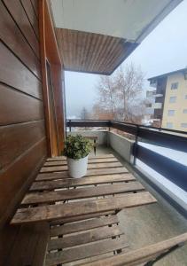 a balcony with a potted plant on a building at La Planchette - La Tzoumaz in Riddes