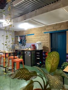 a room with a kitchen with a table and a counter at Chirris Hostel in San Juan La Laguna