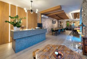 a lobby with a counter and a dining room at Hotel Sinan Han in Mostar