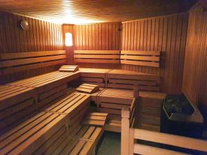 an empty sauna with wooden benches and a light at DAS APPARTEMENT INSELLIEBE RÜGEN inkl Sauna und 3h täglich Eintritt AHOI Schwimmbad in Ostseebad Sellin +51 photos