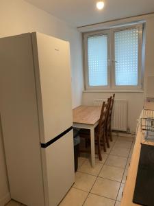 a kitchen with a table and a refrigerator at Central London Serviced Apartment near Borough station SE1 in London