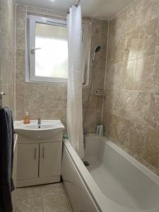 a bathroom with a tub and a sink and a shower at Central London Serviced Apartment near Borough station SE1 in London