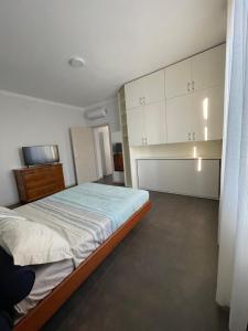 a bedroom with a bed and white cabinets at Marchionis in Cremona