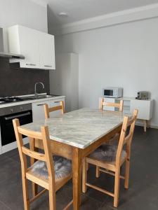 a kitchen with a wooden table and chairs in a kitchen at Marchionis in Cremona +22 photos