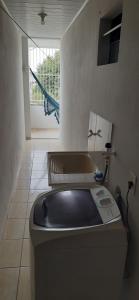 a bathroom with a tub and a toilet in a room at Condomínio Vitória in Vila Velha