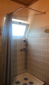 a bathroom with a shower with a shower curtain at THEO TRADITIONAL HOUSE in Eptalofos