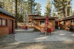 a patio with chairs and a cabin at Hot tub*kids room*family cabin in Big Bear City