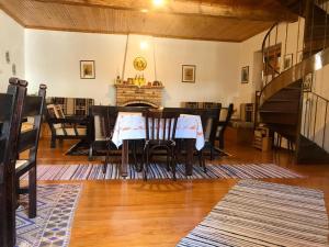 a dining room with a table and chairs and a fireplace at THEO TRADITIONAL HOUSE in Eptalofos