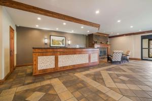 a lobby with a bar and a fireplace at Best Western University Inn in Canton