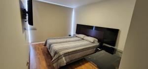- une petite chambre avec un lit et une télévision dans l'établissement Grimaldo del Solar 219 Miraflores OMM1, à Lima