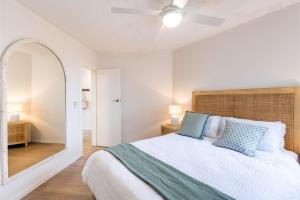a bedroom with a large bed and a mirror at Thurlow Lodge, 7,6 Thurlow Avenue - Beautifully styled unit with WiFi, views and a pool in Nelson Bay