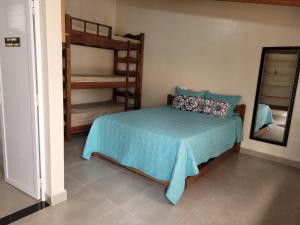 a bedroom with a bed and a mirror and bunk beds at Lago e Lazer in São Roque +78 photos