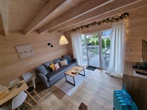 a living room with a couch and a table at DOMKI ZACHÓD SŁOŃCA w Ustroniu Morskim in Ustronie Morskie