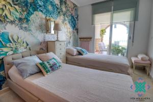 a bedroom with two beds and a couch at Vida Mia Almeria - Superior Apartment in Vera