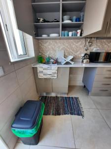 a small kitchen with a blue ottoman on the floor at Blue Sardine Hostel in Portimão