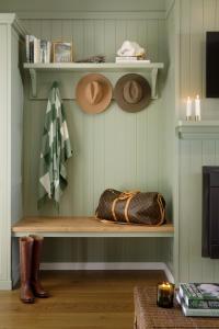 a shelf with hats and a purse and boots at Verandah House Country Estate in Mount Tamborine