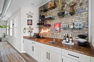 a kitchen with a sink and a brick wall at The Bentley Condotel, Heart of Walkers Point with Garage, Yard in Milwaukee