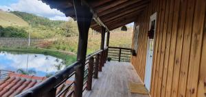 a porch of a house with a view of a river at Casarão Biazolli in Farroupilha