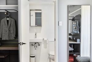a bathroom with a sink and a toilet at No 9 Springfield in Sydney