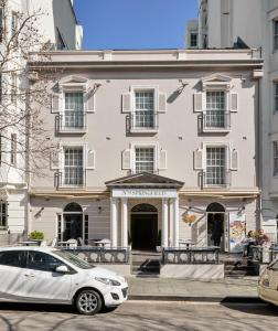 a white car parked in front of a building at No 9 Springfield in Sydney