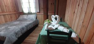 a bedroom with a bed and a table with towels at Casarão Biazolli in Farroupilha