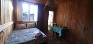 a small bedroom with a bed with a baby on it at Casarão Biazolli in Farroupilha