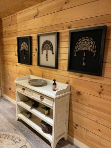 a white dresser in a room with wooden walls at Hotel Palafito Entre Mar y Tierra in Castro