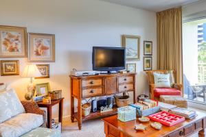 a living room with a tv on top of a dresser at Sterling Shores 205 in Destin
