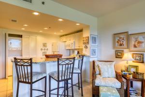 a kitchen with two bar stools and a counter at Sterling Shores 205 in Destin