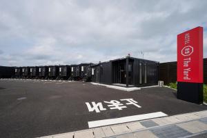 a row of shipping containers in a parking lot at HOTEL R9 The Yard Koka in Koka