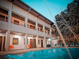 a house with a swimming pool and a fountain at Charms Hotel in Coron