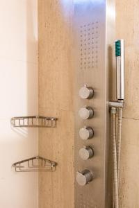 a shower with two shelves and a toothbrush at Aloe Village Aparthotel & Spa in La Paloma