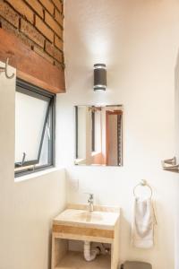 a bathroom with a sink and a mirror at CASA ANTARES in Tepoztlán