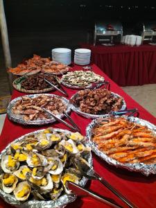 a table with many different types of food on it at Suoi Hong Resort in Mui Ne