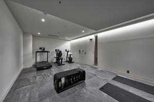 a gym with two exercise bikes in a room at Hotel Lepo Chahal in Matsuyama