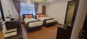 Ένα ή περισσότερα κρεβάτια σε δωμάτιο στο Durbar Hotel & Residence