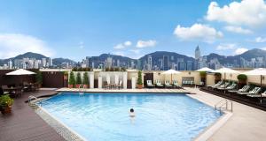 a swimming pool with a large swimming pool in the middle of it at InterContinental Grand Stanford Hong Kong, an IHG Hotel in Hong Kong