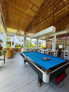 a pool table in the middle of a patio at Red Picnic Hostel in Panglao Island