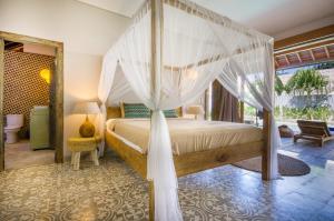 a bedroom with a bed with a canopy at 3 BDRMS private VILLA - Bingin Beach in Uluwatu