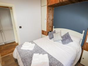 a bedroom with a large white bed with pillows at Celyn in Ruthin