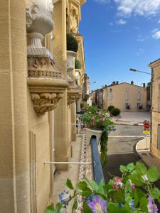 a street with flowers on the side of a building at The Suites in Blaye