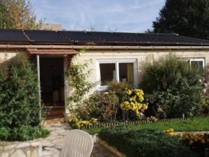 a small house with solar panels on the roof at PARIS COTTAGE MONT VALERIEN - HEIGHTS OF PARIS in Suresnes