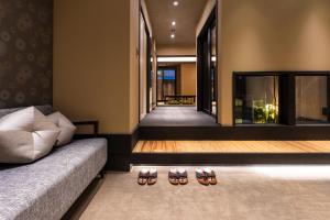 a living room with two pairs of shoes on the floor at Rinn Kiyomizu Gojo Machiya in Kyoto