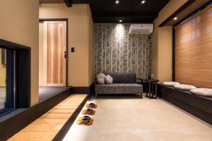a waiting room with a chair and some shoes on the floor at Rinn Kiyomizu Gojo Machiya in Kyoto
