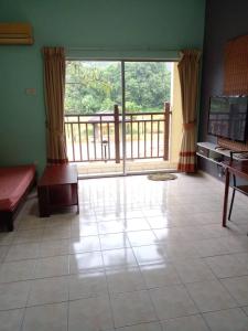 a living room with a large window and a balcony at Bukit Merah 99 Motel(Suria Apartment) in Kampong Selemat