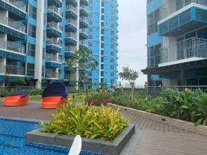 a swimming pool in front of some apartment buildings at Le Maisse Executive Studio 1BR opp Okada in Manila