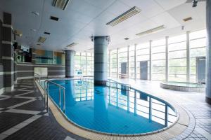 a large pool with blue water in a building at Otaru Asari Classe Hotel in Otaru