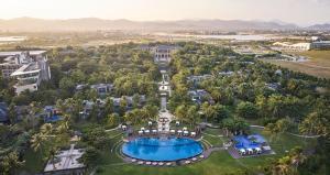an aerial view of a resort with a pool at Wanda Reign Resort & Villas Sanya Haitang Bay in Sanya
