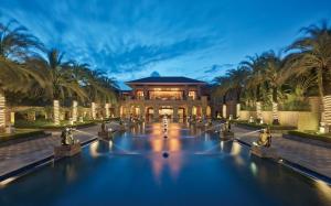 a large building with a fountain in front of it at Wanda Reign Resort & Villas Sanya Haitang Bay in Sanya