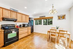 a kitchen with wooden cabinets and a table and a stove at Summit House in Guerneville